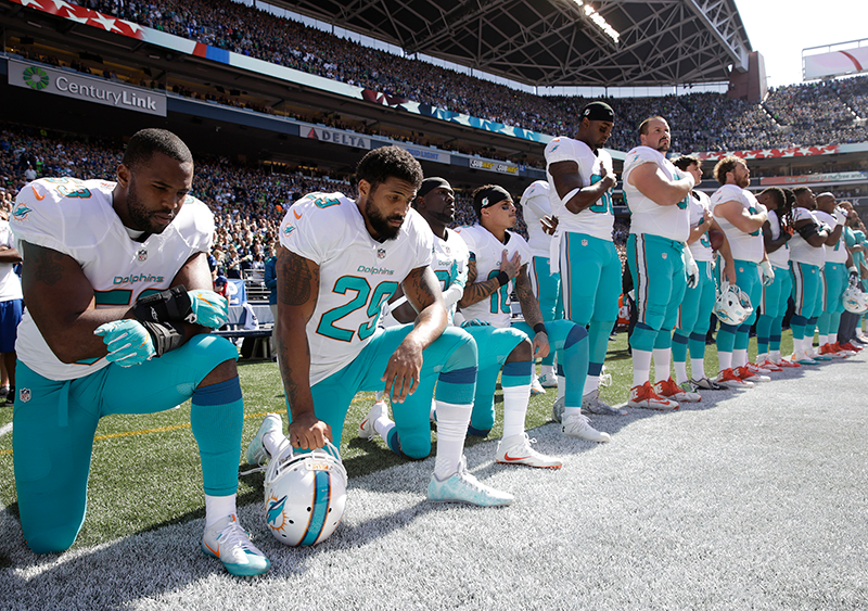 Miami Dolphins wide receivers Kenny Stills and Albert Wilson kneel prior to  preseason opener